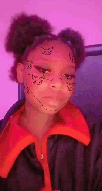 a girl with pigs painted on her face is wearing a red jacket