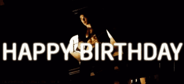 a man without a shirt is standing in front of a sign that says happy birthday .