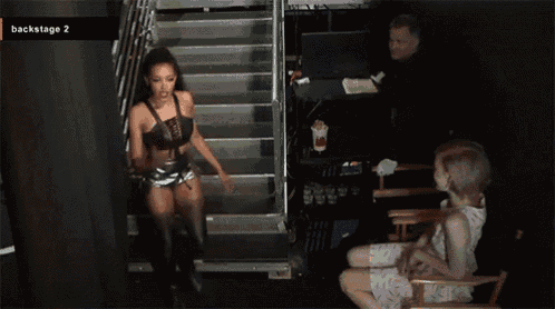 a woman walking down a set of stairs with the words backstage 2 on the bottom