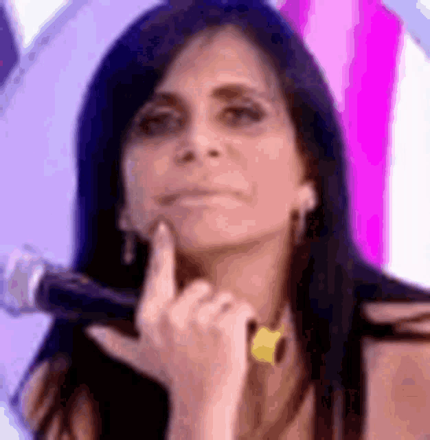a woman is holding a microphone in her hand .