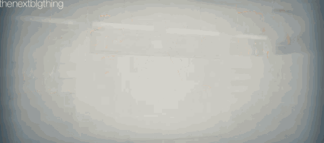 a blurry picture of a building with the next big thing written on the bottom right