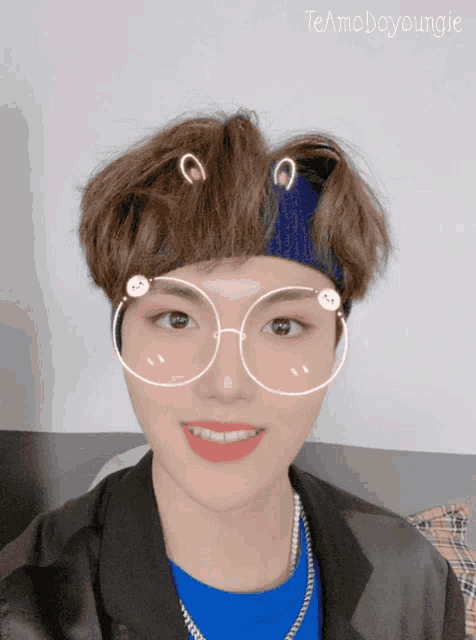 a young man wearing glasses and a headband with the name teamodayyoungie on the bottom