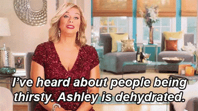 a woman is sitting in a living room talking about people being thirsty . ashley is dehydrated .
