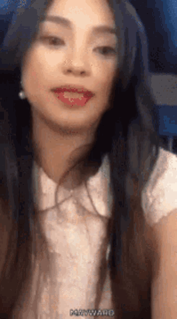 a close up of a woman 's face with long hair .