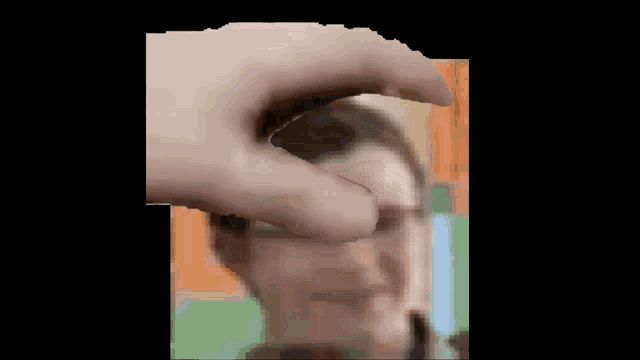 a blurry picture of a person 's face with a hand on it