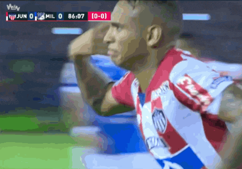 a soccer player in a red and white uniform celebrates a goal during a game