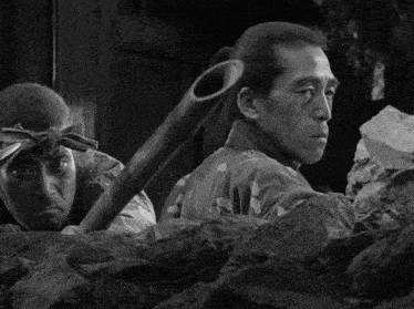 a black and white photo of a man holding a cane