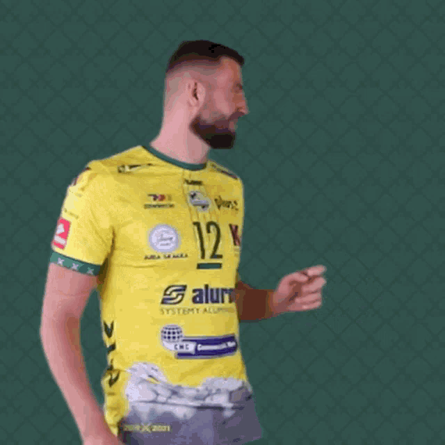 a man is wearing a yellow shirt with the number 12 on it