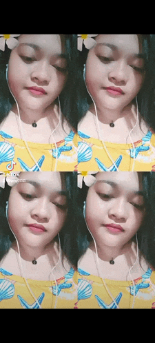 a girl is wearing headphones and a yellow shirt with seashells .