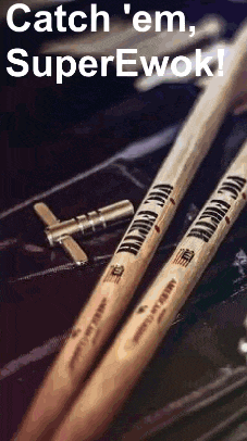 a pair of vic firth drum sticks are sitting on top of a drum set .