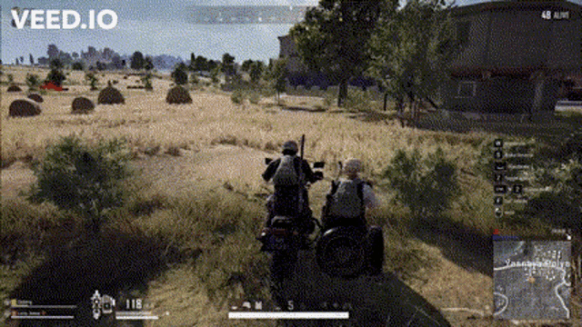 a man in a wheelchair is riding a motorcycle in a video game while another man stands behind him .