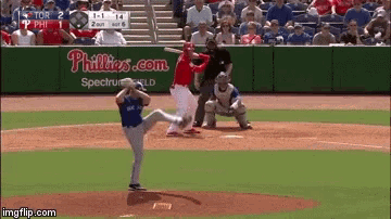 a baseball game is being played in front of a phillies advertisement