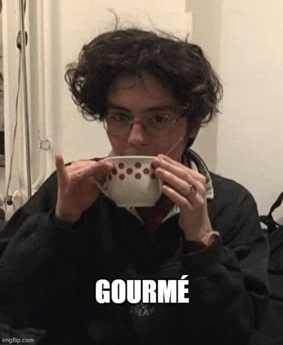 a young man wearing glasses is drinking from a bowl with the word gourmet below him .