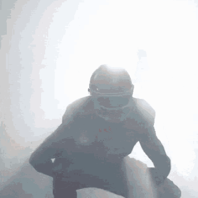 a silhouette of a football player with a helmet on