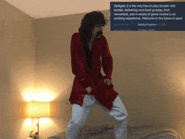 a man in a red robe is dancing in front of a sign that says " spitgate 2 "
