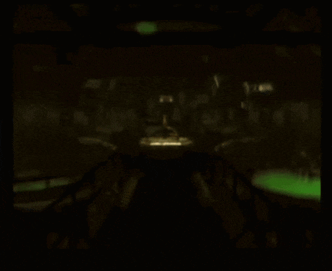 a blurry picture of a dark room with a green container in the corner
