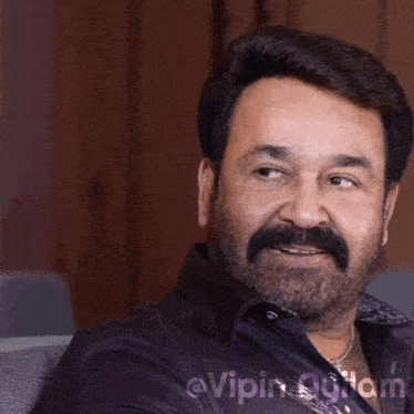 a close up of a man with a beard and a caption that says @vipin ayilam