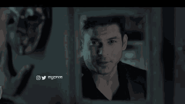 a man is looking at himself in a mirror with a twitter icon above him