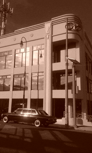 a black car is parked in front of a building that says ctv on it