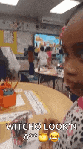 a little girl in a classroom with the words witcho look n a on her face
