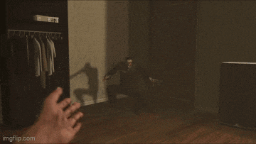 a screenshot of a video game shows a monster reaching out towards a person 's hand .