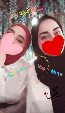two women with hearts on their faces and one has the name yas mine written on her shirt