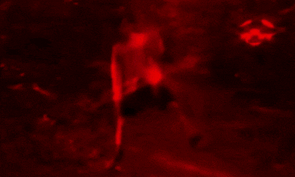 a blurry picture of a man in a red light
