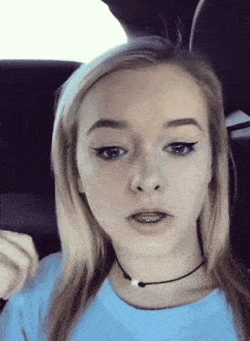 a young woman with braces on her teeth is wearing a choker