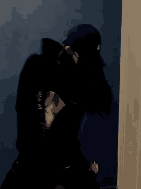 a blurry picture of a woman wearing a hat and a black shirt .