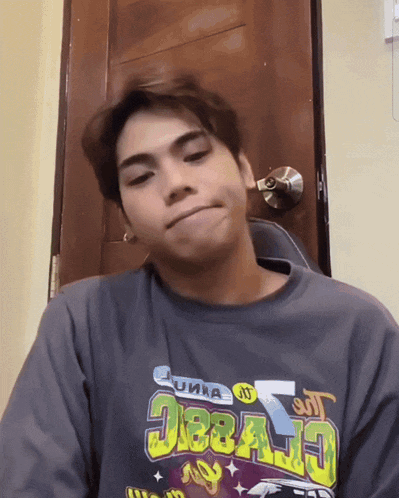 a young man wearing a shirt that says ' deejay ' on it