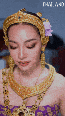 a woman is wearing a purple dress and gold jewelry with the word thailand below her