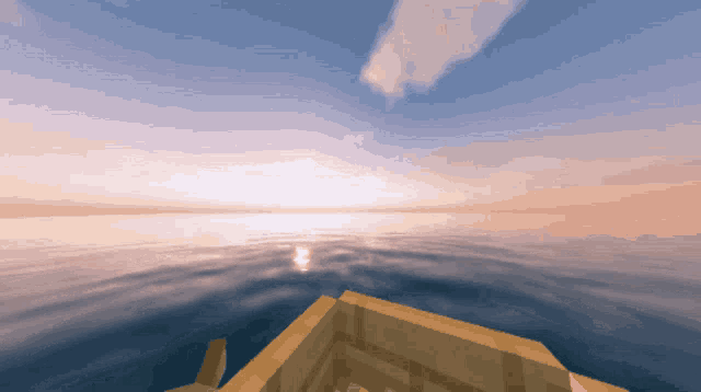 a wooden boat is floating in the ocean at sunset