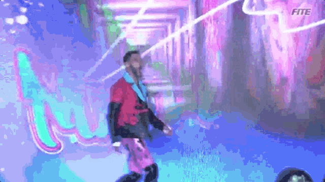 a man in a red shirt and pink pants is standing in a tunnel .