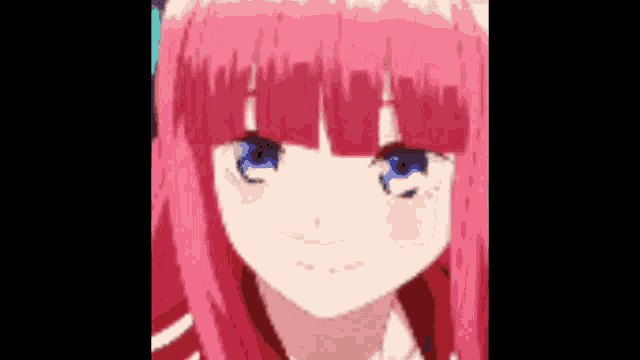 a close up of a girl with pink hair and blue eyes looking at the camera .