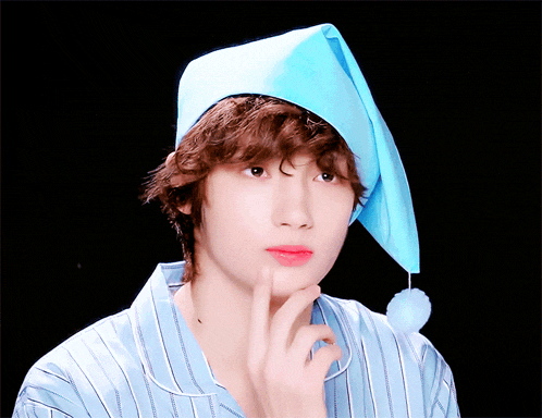 a young man wearing a blue hat and pajamas