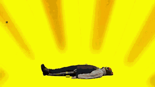 a man in a red shirt that says i am a winner is laying on the ground surrounded by other people