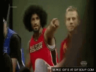 a man in a red jersey that says let 's go boxer is pointing at something