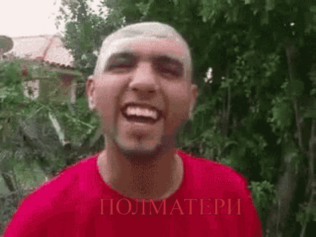 a man in a red shirt is smiling with the word polimateri in the corner