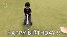 a baby is laying on the ground with the words `` happy birthday '' written on the ground .