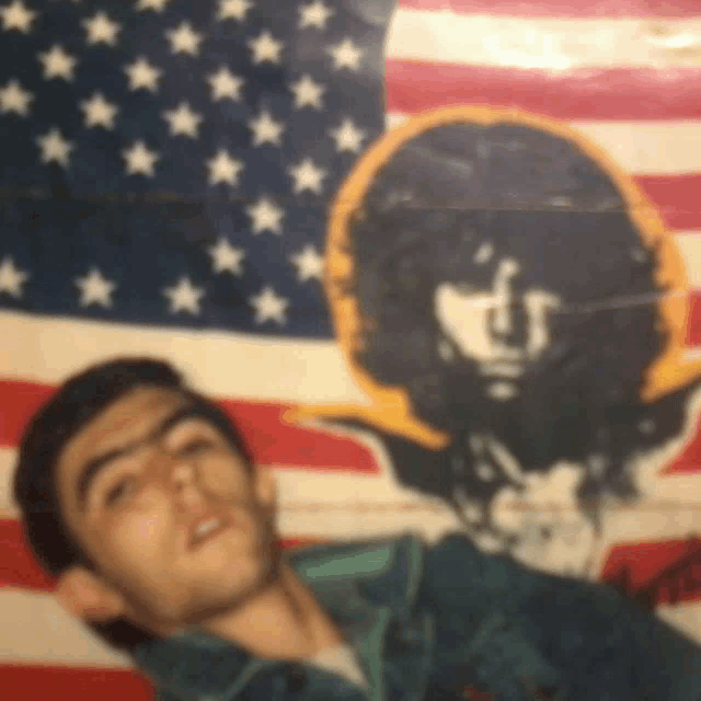 a man is laying in front of an american flag with stars