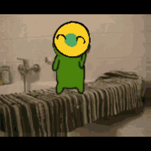 a green cartoon character with a yellow face is standing on a towel
