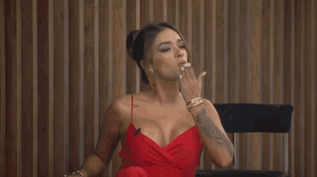 a woman in a red dress with her eyes closed
