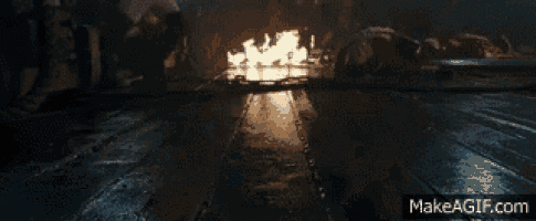 a dark room with a fire coming out of it and the url makeagif.com