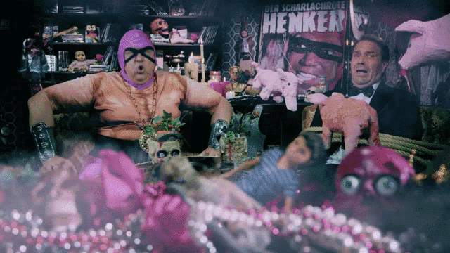 a man in a tuxedo stands in front of a poster that says henker on it