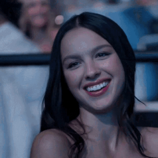 a close up of a woman 's face smiling at the camera
