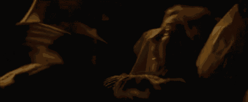 a man in a suit and tie is holding a woman 's hand in the dark .