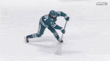a blurry picture of a hockey game with the msg logo in the upper right corner