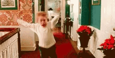a child is jumping in the air in a hallway .