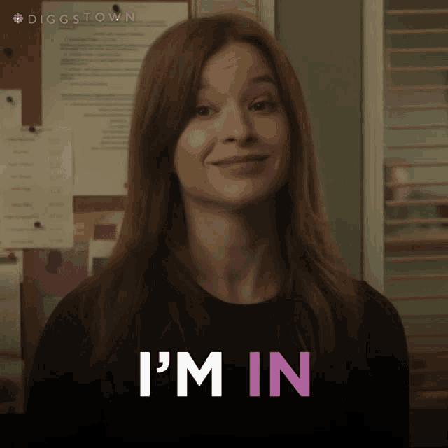 a woman in a black shirt says i 'm in in pink letters