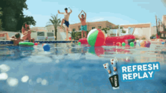 a group of people are jumping into a swimming pool with a refresh replay advertisement in the background
